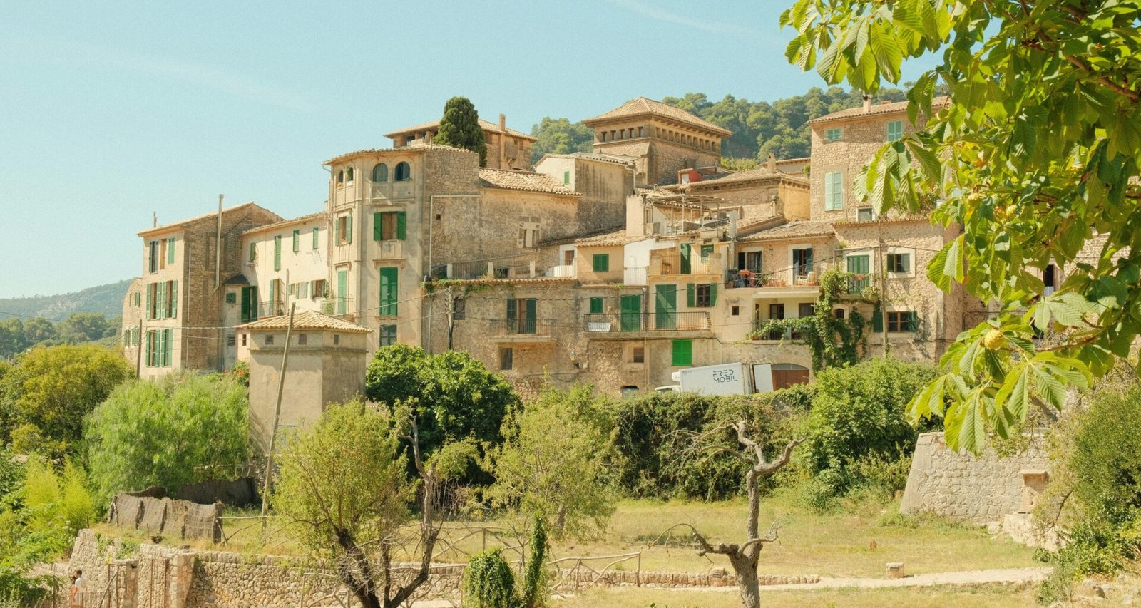 Ein Dorf mit vielen Gebäuden und Bäumen auf Mallorca, aufgenommen von Alex.
