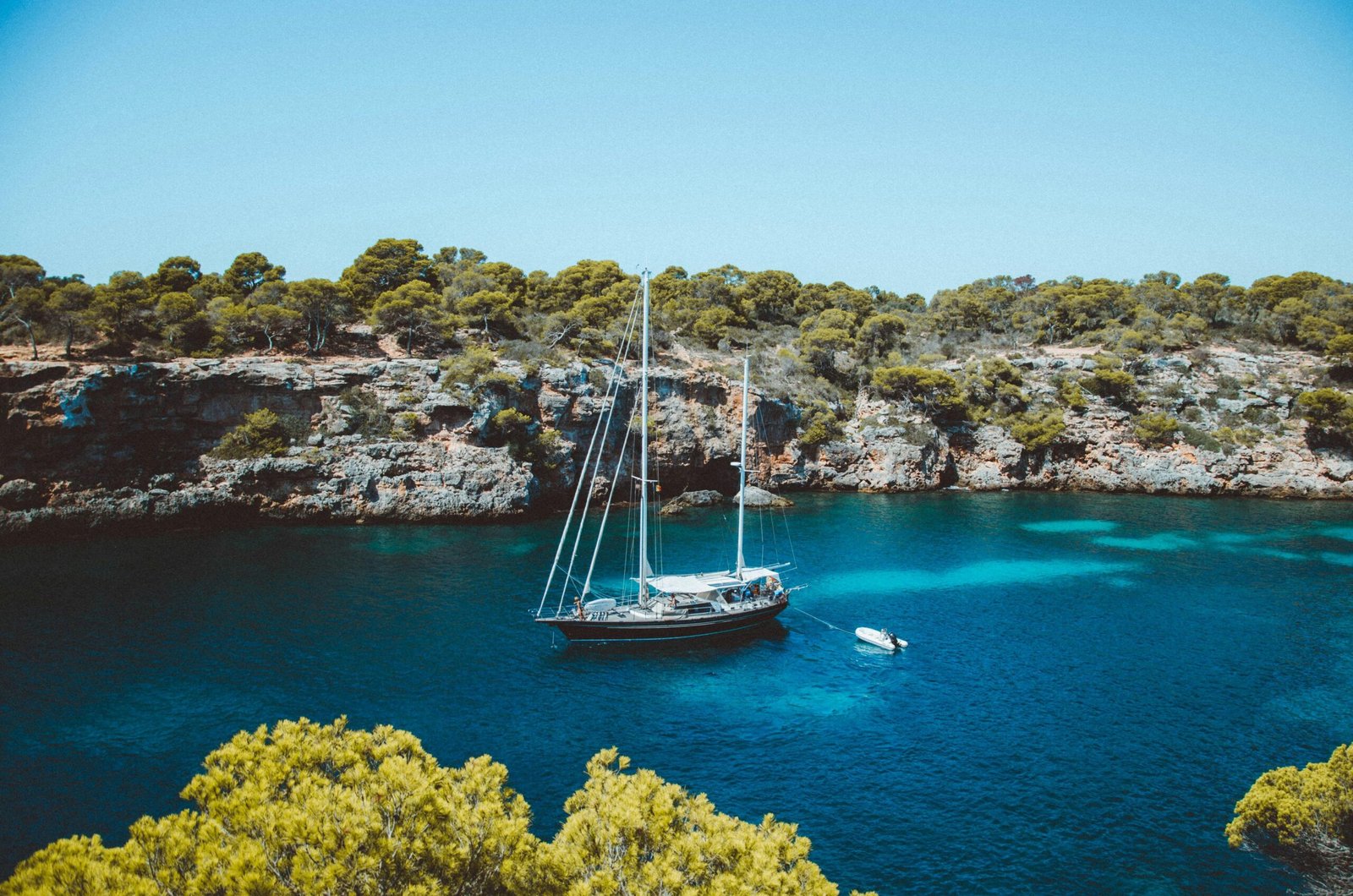 Braunes und weißes Segelboot auf Mallorca treibt ruhig im Mittelmeer, fotografiert von Michael Heuser.
