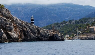 Leuchtturm auf Mallorca auf einem Wasserbecken mit Blick auf das offene Wasser, aufgenommen von Artur Łuczka.