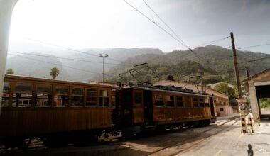 Ein Zug fährt auf Mallorca entlang der Bahnstrecke neben Bergen, aufgenommen von Victor Oonk.