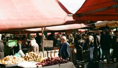 Gruppe von Menschen beim Einkaufen auf einem Markt auf Mallorca, Stände mit frischen Produkten