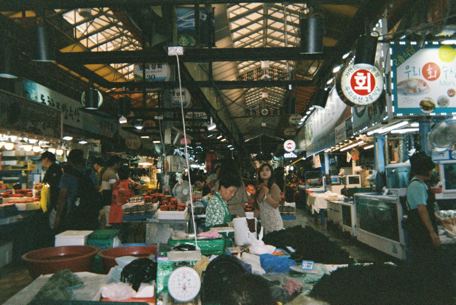 Gruppe von Menschen steht um einen Markt auf Mallorca, fotografiert von Chorom Park