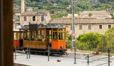 Oranger Trolley fährt die Straße entlang auf Mallorca, aufgenommen von Artur Łuczka.