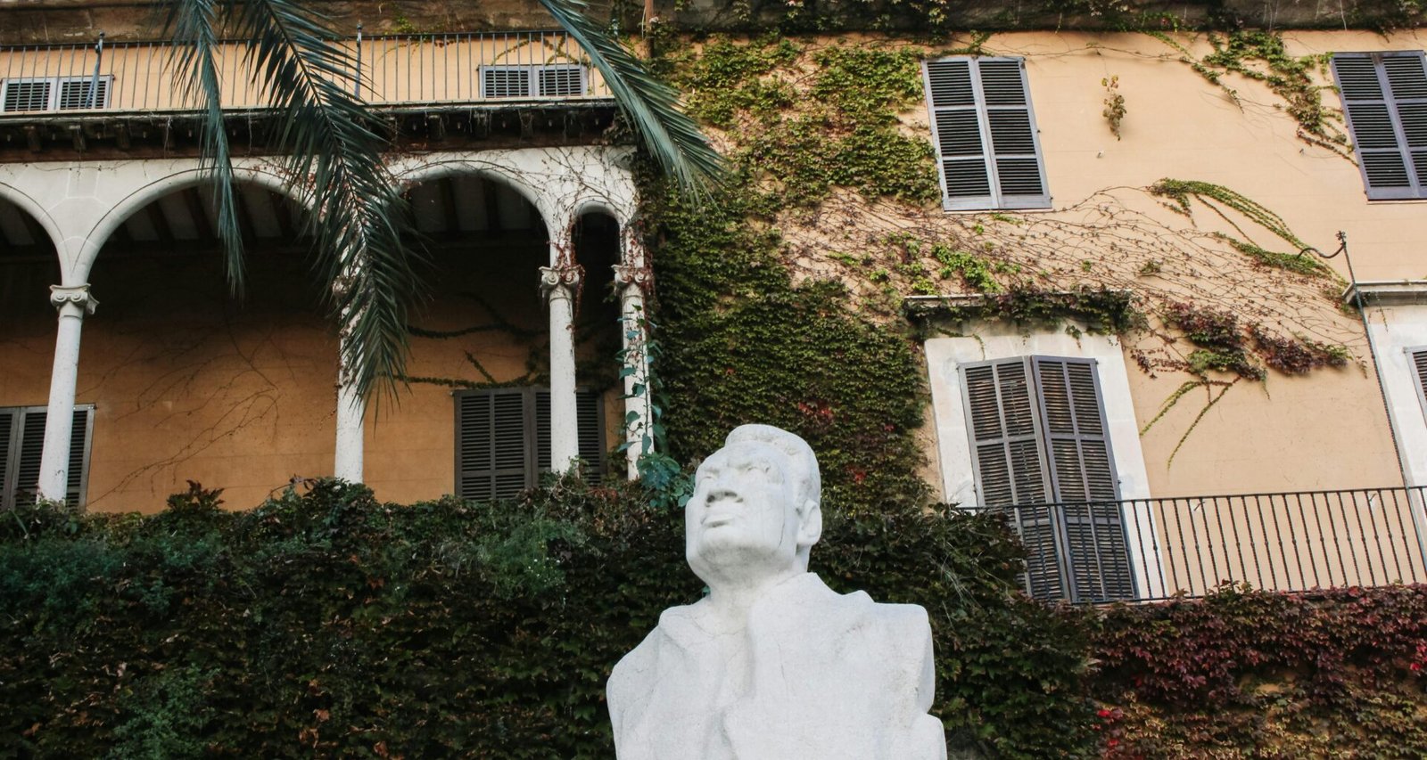 Statue eines Mannes vor einem Gebäude auf Mallorca, aufgenommen von Behnaz