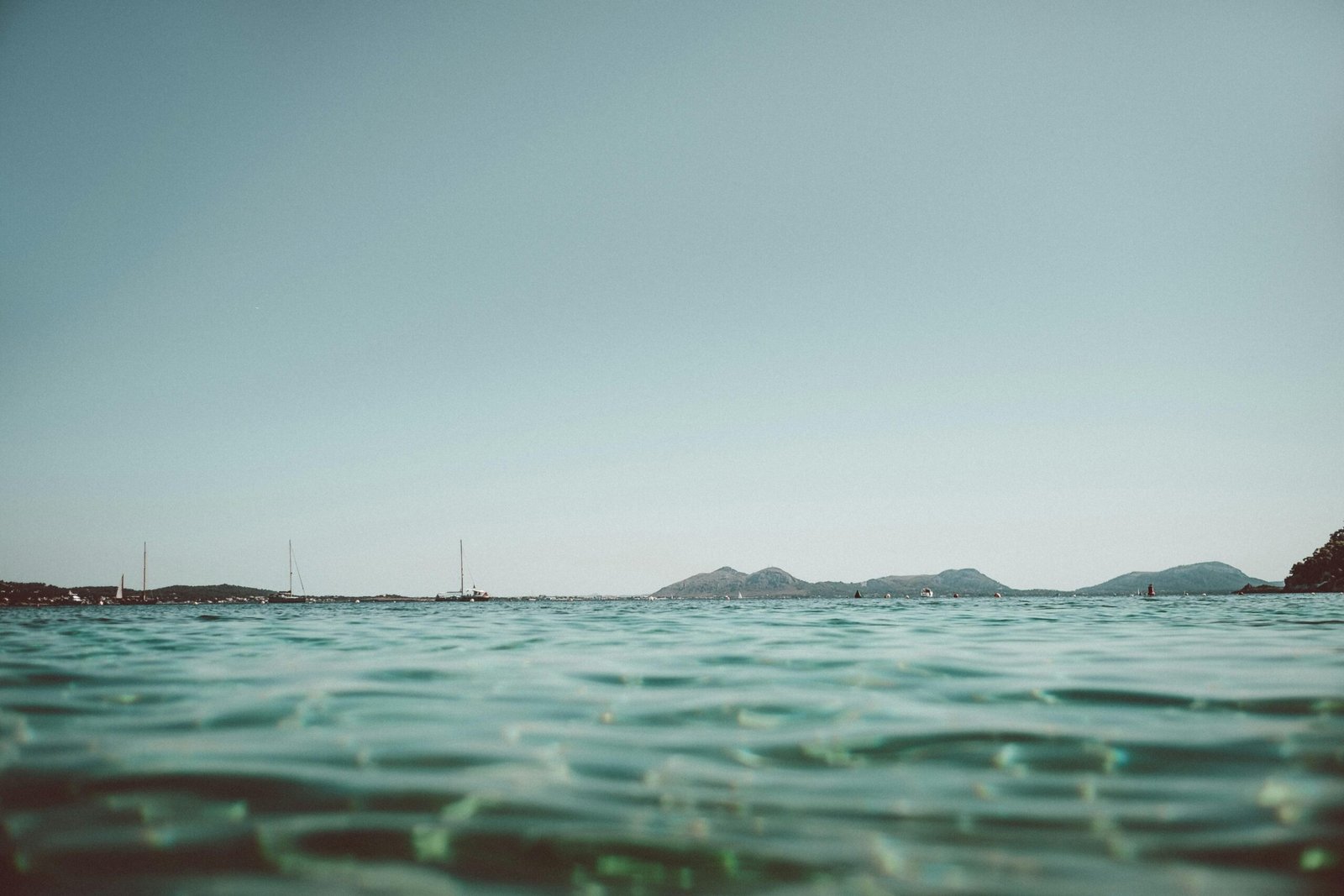 Blick auf das ruhige Wasser auf Mallorca, aufgenommen von Tobias, mit sanften Wellen und natürlicher Umgebung.