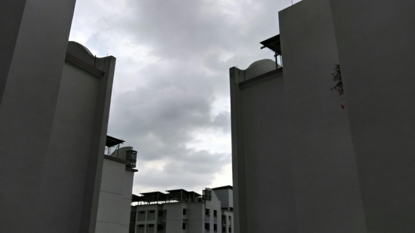 Tall buildings against a cloudy sky on Mallorca, photographed by karis.