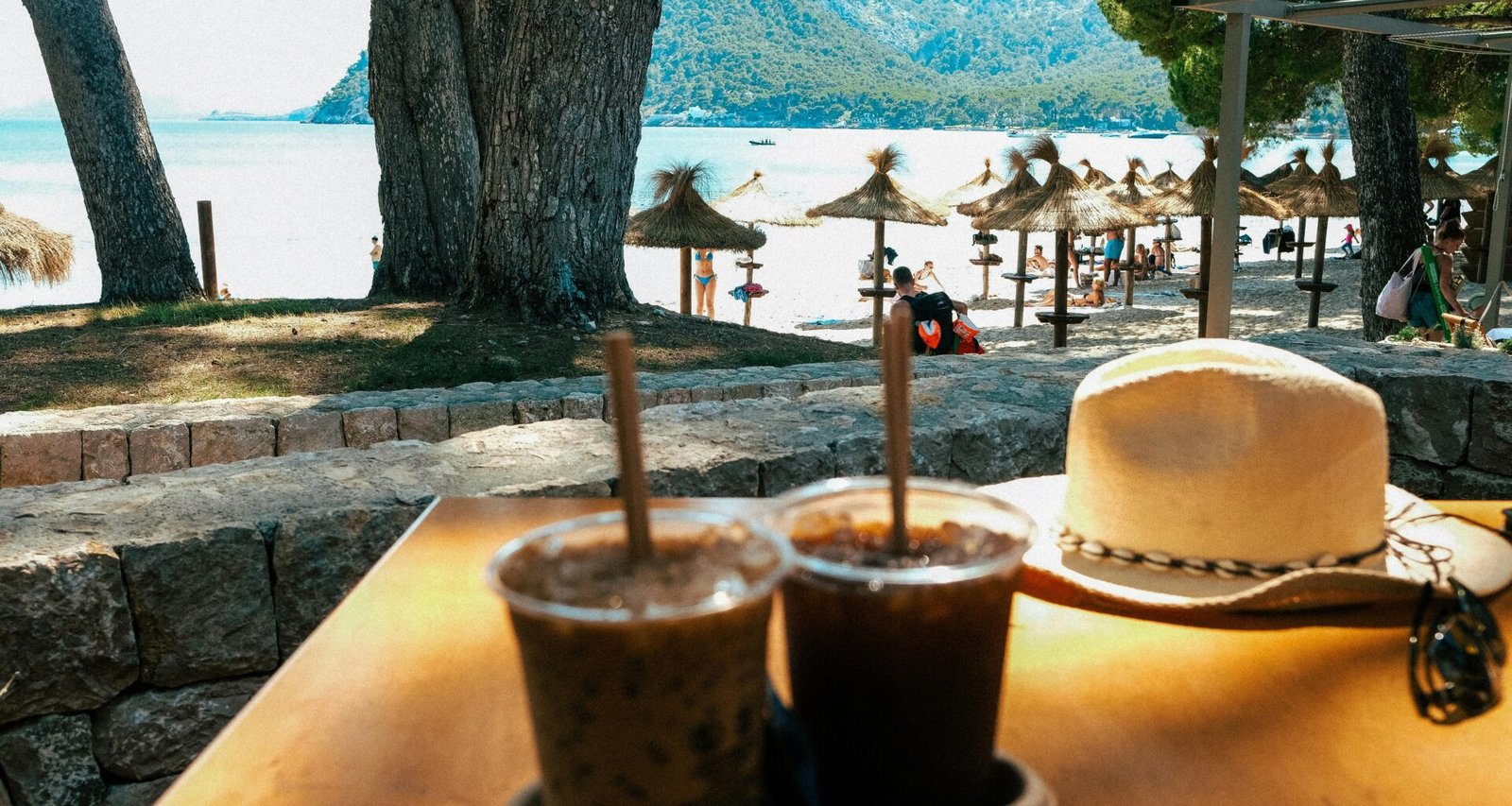 Zwei Getränke und ein Hut liegen auf einem Tisch auf Mallorca, aufgenommen von Luke Moss.