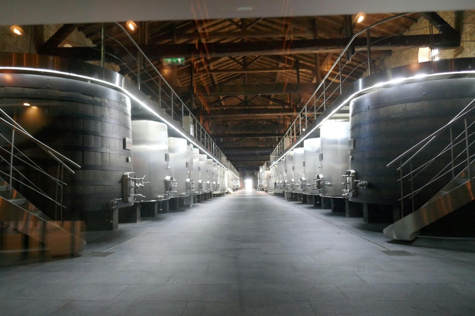 Innenansicht eines Weinlagers auf Mallorca mit großen Lagerbehältern, fotografiert von Carnet de Voyage d'Alex